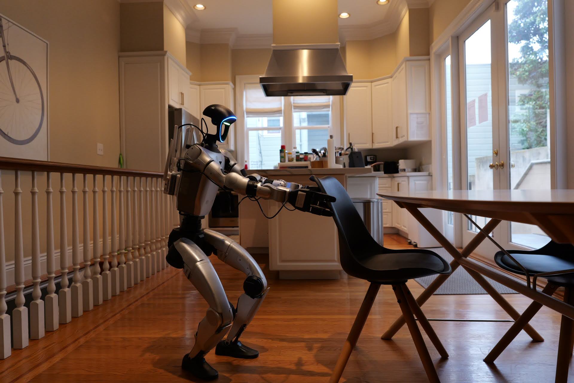 Robot pulling out a chair in the dining area